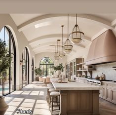 a large kitchen with lots of windows and counter space next to an outdoor swimming pool