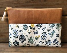 This rifle paper co. floral vegan leather cosmetic makeup bag in the Hawthorne Periwinkle print makes a great gift as a makeup bag, bridesmaid gift, travel bag, pencil pouch, school and craft supply bag, handheld clutch and trendy purse to grab on the go! If you like pretty floral items, for yourself or to gift to others, you simply cannot pass up the lovely rifle paper co. print bags.  These bags makes beautiful affordable gifts for your friends, co-workers, teachers, bridesmaids, or simply for yourself. Features: Size: 9 inches wide x 7 inches tall Fabric: 100% cotton + vegan leather Tassel zipper pull Ready to ship These bags make great bridesmaid gifts or holiday gifts for women under $20! Spot clean only with damp cloth. What sets these zippered pouches apart from others?  I only use Periwinkle Makeup, Makeup Travel Bag, Paper Pouch, Vegan Purses, Makeup Travel, Small Gift Bags, Vegan Leather Bag, Ladies Clutch, Affordable Gifts