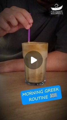 a person holding a purple straw in front of a glass filled with liquid and the words morning greek routine