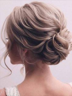 a woman with her hair in a low bun