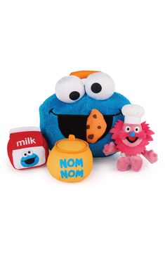 a blue stuffed animal next to some other toy items on a white surface with the words mom now written in large black letters