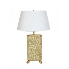 an animal print lamp with a white shade on the base and a gold metal frame