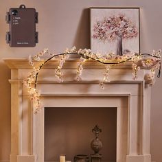 a living room with a fire place and flowers on the mantle