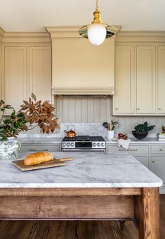 a kitchen with marble counter tops and wooden cabinets, along with an island in the middle