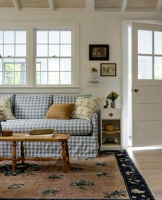 a living room filled with furniture and lots of windows