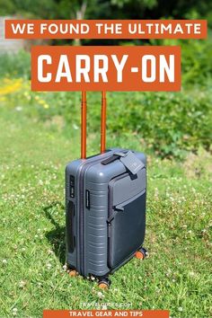 a suitcase sitting on top of a green field next to a sign that says, we found the ultimate carry - on