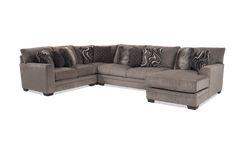 a large sectional couch with pillows on the top and bottom corner, in grey fabric