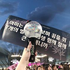 a person holding up a trophy in front of a crowd