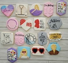 many decorated cookies are arranged on a wooden surface with words and pictures in the middle