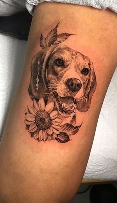 a black and white photo of a dog with sunflowers on it's leg