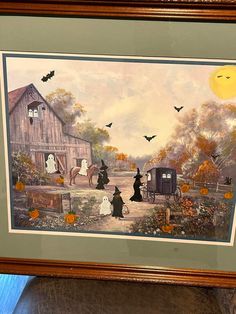 a framed painting of halloween scene with pumpkins and ghost on the farm by a barn