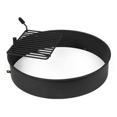 a black grill on top of a white surface with the lid open and an empty pan underneath it