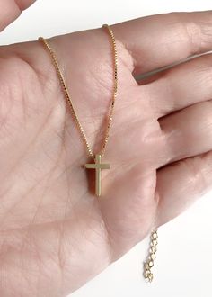 "Dainty Cross Necklace This is a delicate and minimalist 24K gold plated box chain with a 24k gold plated dainty cross through it. It is adjustable from 17.5\" to 19.5\" / 45cm to 50 cm This simple piece would be a perfect accessory for a bride, first communion, confirmation or as an everyday necklace that goes with anything. This necklace is designed to be worn all day. DETAILS: Necklace length: 17.5\" / 45 cm plus 2\" extension chain 24K Gold plated charm Cross measures: 0.5\" / 1 cm It is car Christ Necklace, St Jude Necklace, Cross Necklace Gold, Dainty Cross Necklace, Catholic Jewelry, Gold Cross Necklace, Necklace Simple, Everyday Necklace, Catholic Gifts