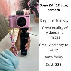 a person holding up a pink camera in front of a mirror with the words, sony zv - 1f vlog camera