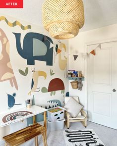 a child's room with an elephant and giraffe mural on the wall