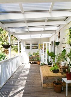 a porch with potted plants on it