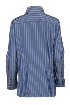 The classic feel of this striped Lafayette 148 button up is modernized with a loose fit. A cotton and silk blend feels good on the skin, making it an easy choice for weekend errands. Style this classic piece with denim or tailored pants for a casual Friday at work. Size L 73% Cotton, 27% Silk Loose fit Long length Long sleeves Brown buttons Bust 38" Waist 36" Shoulder to hem 28" Sleeve length 24" Casual Pinstripe Tops With Button Cuffs, Striped Tops With Button Cuffs And Relaxed Fit, Casual Pinstripe Shirt With Buttons, Casual Friday, Tailored Pants, Luxury Fabrics, Button Up Shirt, Long Length, Modern Woman