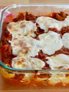 a casserole dish with meat and cheese in it sitting on a table top