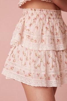 Our best selling Ruffle Mini Skirt returns for the season with a dainty floral printed cotton voile fabric. She features intricate inset lace trims and allover pintuck details. The elasticated waistband and double lining offers flexibility in comfort and styling. Tiered ruffles exude effortless femininity. The mini is finished with a frayed, raw hem for added playfulness. Pair with the Beaming Smocked Top for a full look. Description Our best selling Ruffle Mini Skirt returns for the season with Early Spring Outfits Casual, Fancy Skirts, Spring Trends Outfits, Romantic Floral Print, Cotton Voile Fabric, Voile Fabric, Ruffle Mini Skirt, Early Spring Outfits, Princess Outfits