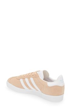 Initially designed as a training shoe for top athletes in 1991, adidas' iconic Gazelle sneaker has been refreshed with a sleek, narrower silhouette but retains the classic contrasting 3-Stripes and heel tab of the original, and is presented in throwback archival hues. Lace-up style Cushioned footbed Removable insole Leather or leather and synthetic upper/textile and synthetic or synthetic lining/synthetic sole Imported BP. Shoes Adidas Low-top Skate Shoes With Contrast Sole, Adidas Synthetic Skate Shoes With Gum Sole, White Sole Sneakers With Gum Sole, Adidas Urban Sneakers With Gum Sole, Adidas Sneakers With Gum Sole, Athleisure Lace-up Sneakers For Skateboarding, Adidas Gazelle Sneaker, Down To Earth, Adidas Samba Sneakers