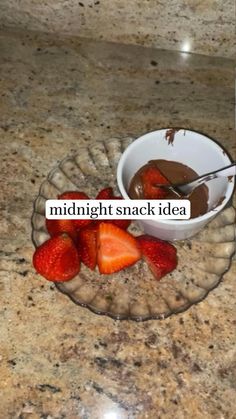 some strawberries and chocolate in a bowl on a counter with the words midnight snack idea