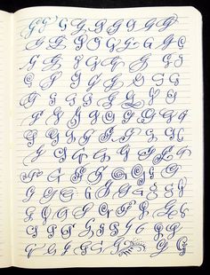 an open notebook with cursive writing on the pages and numbers in blue ink