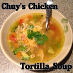 a bowl of chicken tortilla soup with a spoon in it and the title chuy's chicken tortilla soup