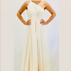 Ivory Metallic, Georgette, Pleated Gown Concealed Hook And Zip Fastening At Side Fully Lined Non-Stretchy, Mid-Weight Fabric 100% Polyester Cream Floor-length Evening Dress For Prom, One Shoulder Pre-draped Wedding Dress, Elegant Cream Dress For Prom Season, Cream Floor-length Prom Dress, Cream Gown For Prom, Elegant Cream Prom Dress, Cream Pre-draped Evening Dress, Fitted Cream Gown For Bridesmaid, Cream Maxi Dress For Prom