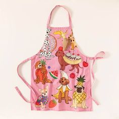 a pink apron with dogs and pineapples on it