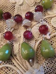 "One strand beaded neckkace made with 18mm long and 12mm wide jade, and inlaid 12mm crystal inlaid jasper. The burgandy jasper is 10mm. This stunning necklace is 18 3/4\" long. Great fall colors. The stones have a beautiful luster and are faceted with the exception of the inlaid jasper." Costume Jewelry With Faceted Dangle Beads, Unique Jade Round Bead Jewelry, Artisan Jade Jewelry With Gemstone Beads, Artisan Jade Gemstone Bead Jewelry, Unique Jade Gemstone Bead Jewelry, Unique Jade Jewelry With Round Beads, Unique Jade Jewelry With Gemstone Beads, Unique Jade Dangle Jewelry, Beaded Jade Dangle Jewelry