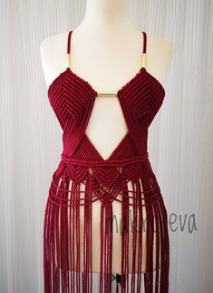 a mannequin with red crochet and fringes on it's torso