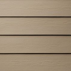 the side of a house with wood siding