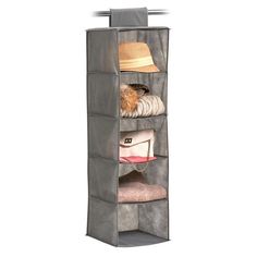 an over - the - door hanging closet with four shelves and hats on it,