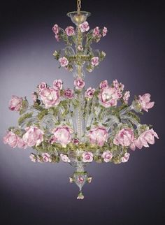 a chandelier with pink flowers hanging from it's sides and green stems