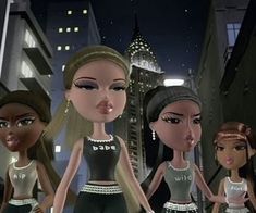 three dolls are standing in the middle of a city at night