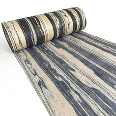 a roll of black and white marbled paper on top of a flooring mat