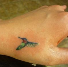 a small hummingbird tattoo on the wrist