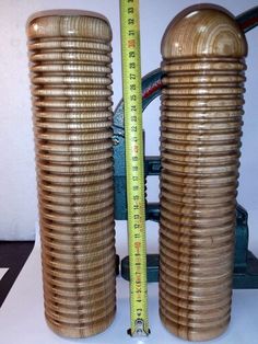 two large brown vases sitting next to a measuring tape