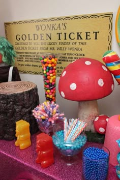 there is a table with candy and decorations on it, as well as a sign that says wonka's golden ticket