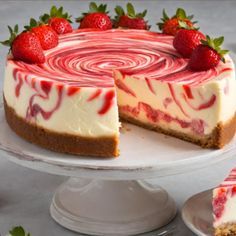 a strawberry swirl cheesecake on a cake plate