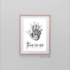 a hand print with the words family in black and white, hanging on a wall