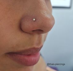 a woman's nose with a tiny white dot on the tip of her nose