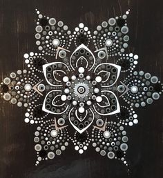 an abstract painting with circles and dots on black wood paneled in silver, white and grey colors