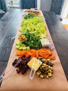 a long table filled with lots of different types of vegetables on top of each other