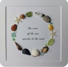 there is a frame with shells and words in the shape of a circle on it