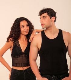 a man standing next to a woman in black clothing