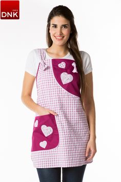 a woman wearing an apron with hearts on the front and pink gingham print