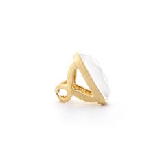 a gold ring with a white stone in the middle