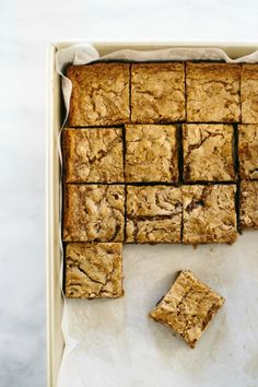 a pan filled with brownies cut into squares and sitting on top of a counter