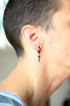 Dangling Cross Earring (1 Earring) Includes: 1 Earring (Sold as a Single)Size:: 18gFinish: Silver or BlackMaterial: Zinc AlloyStyle: DangleClosure: Huggie Dangly Cross Earring Men, Black Male Earrings, Dangling Earrings Men, Cross Earrings Men, Black Skull Ring, Dangle Cross Earrings, Black Earrings Men, Earring For Men, Cross Earring